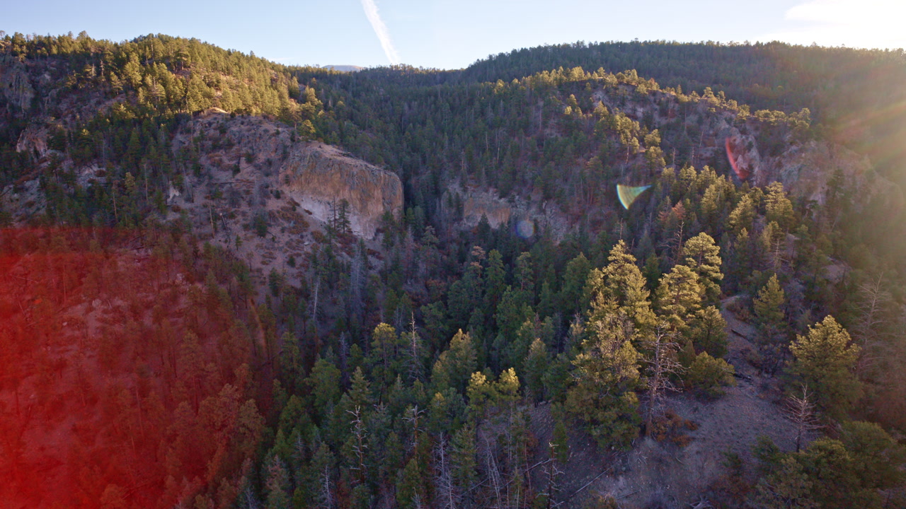 Aerial footage of dramatic cliffs and desert canyon systems near Los Alamos