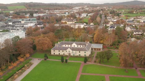 an aerial shot revealing killarney house and gardens in killarney, ireland in the fall