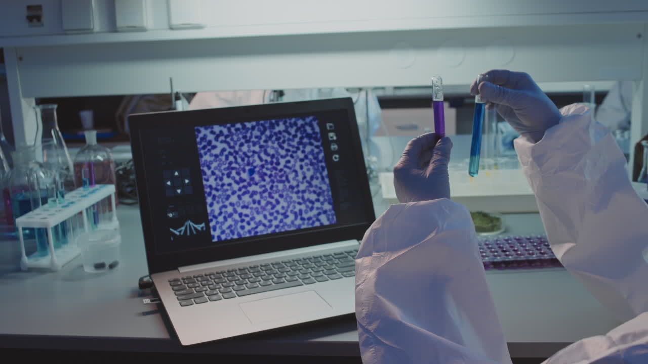 Scientist in Protective Coveralls Analyzing Solution