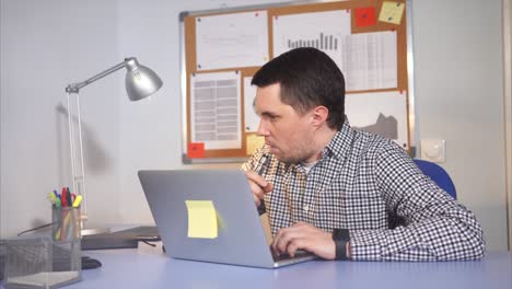 hombre trabajando en una computadora portátil en una oficina