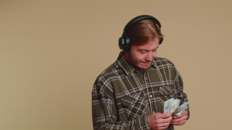 happy man holding fan of money cash celebrate dance, success business career, lottery game winner