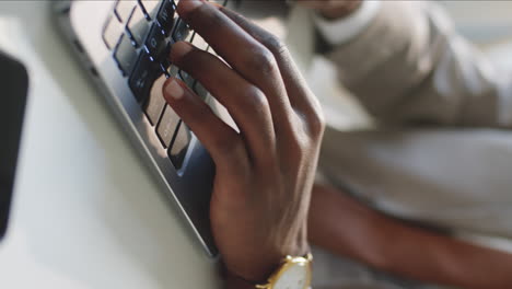 hands of african american businessman typing on laptop