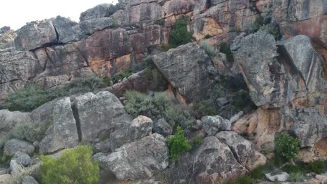 Rocky-mountain-face-outcrop-reveal-shot-with-a-drone