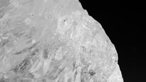 clear white quartz crystals glistening against a dark background, captured through smooth motorized slider panning and macro lens for intricate details