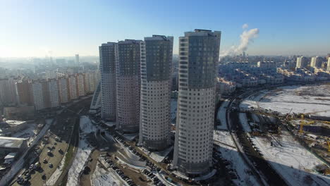 Four-identical-skyscrapers-on-a-megalopolis-background