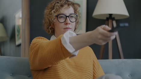 woman watching television on couch