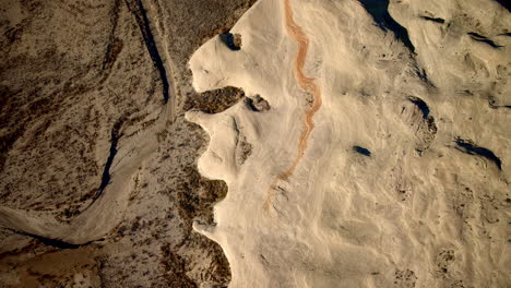drone footage captures the approach to striking rock features by lake powell in page, arizona.