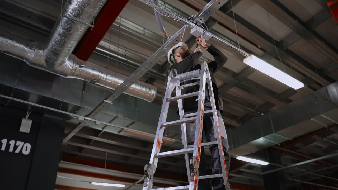 Electrician Installing Ceiling Light Fixture