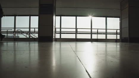 Airport-traveller-backpacker-walking-alone-reaching-check-in-gate-for-boarding-on-a-plane,-silhouette-of-young-solo-travel