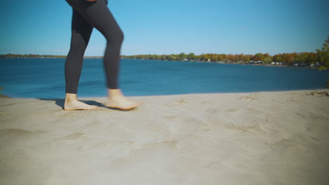 woman walking on a sandy beach in autumn