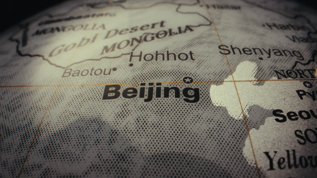 Close-up of a world globe highlighting Beijing and surrounding areas.