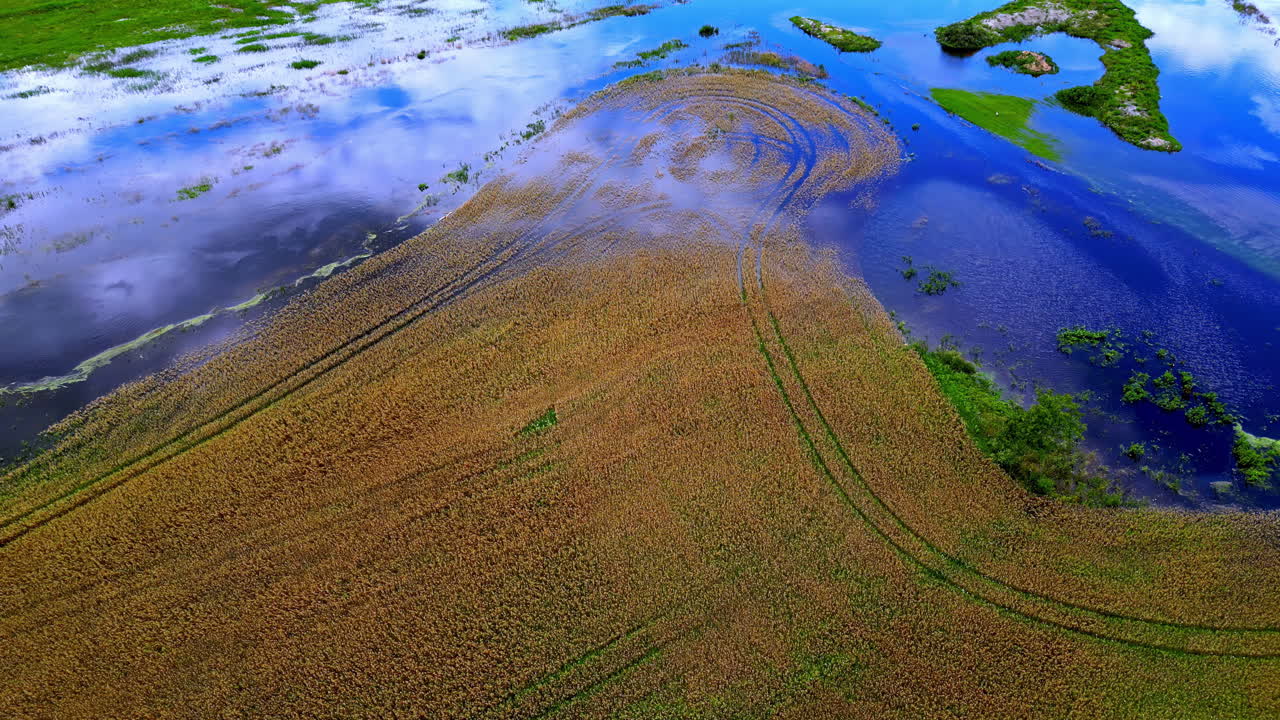 Aerial view overlooking flooding farmland fields, aftermath of torrential rain