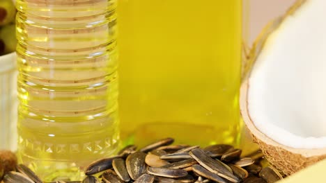 A vibrant display of various healthy fats, including oils, nuts, and avocados, with bright lighting and close-up shots