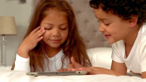 Hispanic-children-playing-together-on-a-tablet