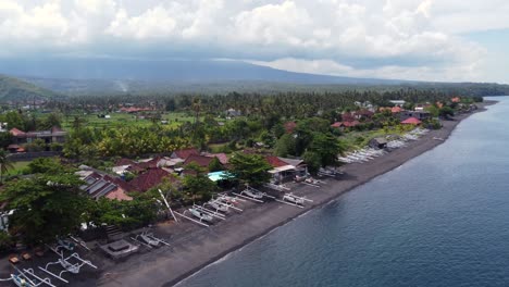 Fertile-volcanic-farmlands-and-black-sand-beach-of-Amed-village-in-Bali,-Indonesia