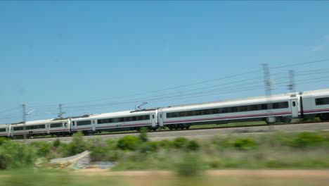 high-speed train moving through spanish landscape