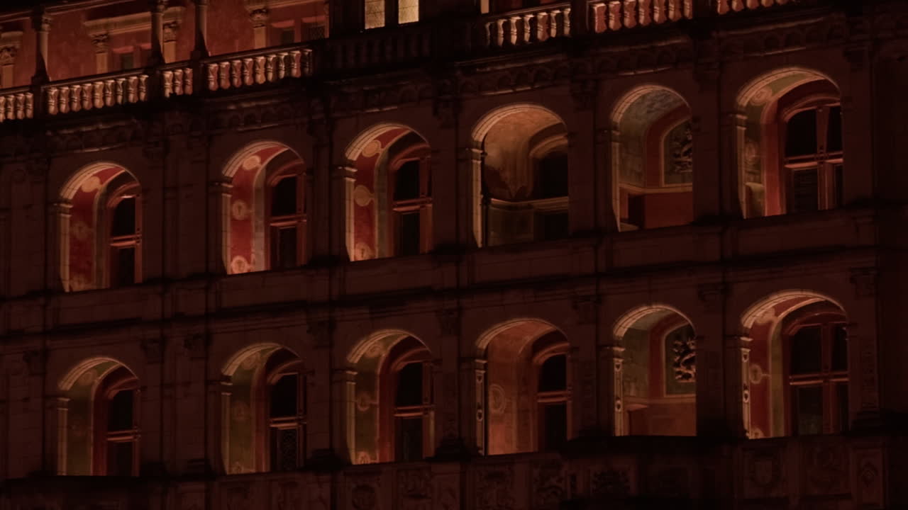 Closeup view of windows of Royal castle of Blois, France. Lighted corridor. Night shot.