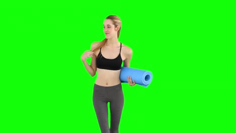 Slim-model-waving-and-holding-exercise-mat