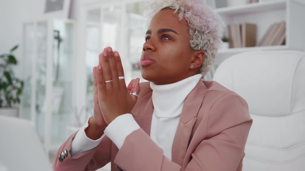 Frustrated african american woman frowns and sighs with frightened face