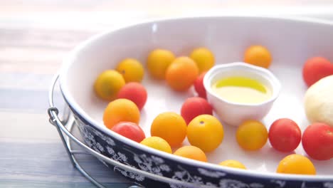 preparing a dish with cherry tomatoes, cheese, and olive oil