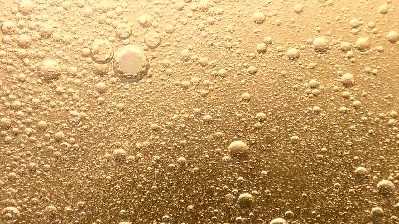 Sfondo di bolle d'olio dorate che scoppiano