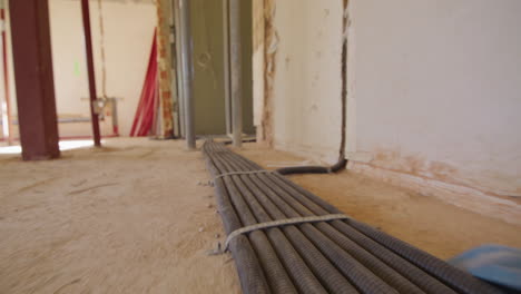 low angle tracking shot following electric cables running on the floor