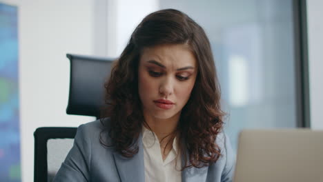nervous businesswoman complaining online meeting sitting company office closeup.