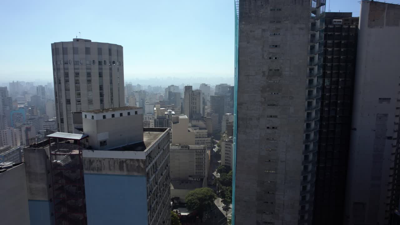 Aerial view rising over streets, past the Edifício Copan, in Republica, Sao Paulo, Brazil