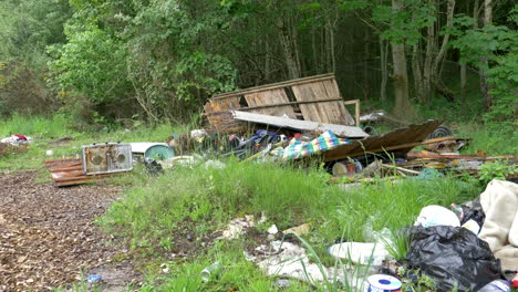 Wide-Shot-Illegal-Trash,-Dumping-In-Nature,-Land-Pollution-4K