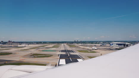 view from the window of an airplane that lands at a large airport