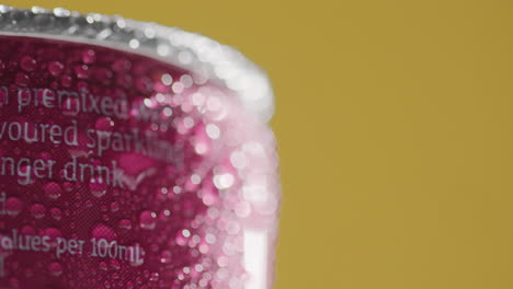 Close-Up-Of-Condensation-Droplets-On-Revolving-Takeaway-Can-Of-Cold-Beer-Or-Soft-Drink-Against-Yellow-Background-With-Copy-Space-3