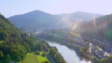 scenic aerial view at valley with river and village on sunny day