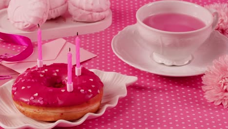 pink birthday celebration with donut and tea