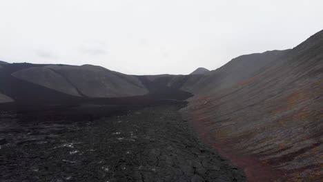 Steaming-black-lava-fields-in-Fagradalsfjall-volcano-crater,-Iceland