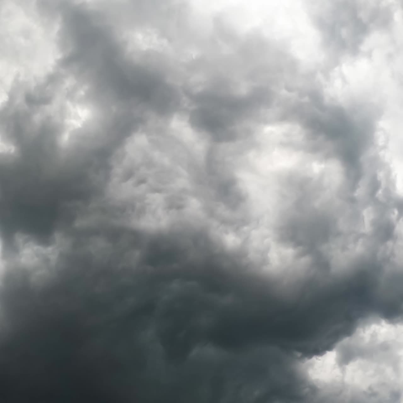 Dark stormy clouds gathering in the sky. Raindrops falling on the camera. View from below. Timelapse