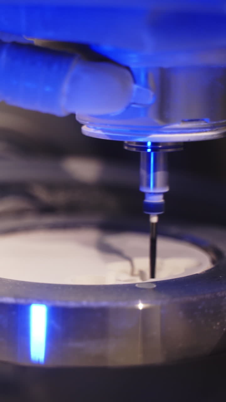 Advanced technology in dentistry. Work of the dental milling machine processing of carving out shape of human teeth. Close-up. Vertical video