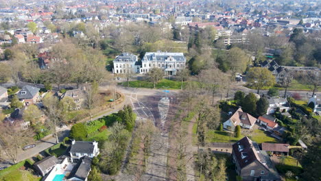 Fliegen-In-Richtung-Großes-Herrenhaus-Am-Ende-Einer-Ruhigen-Straße-In-Einer-Kleinen-Stadt