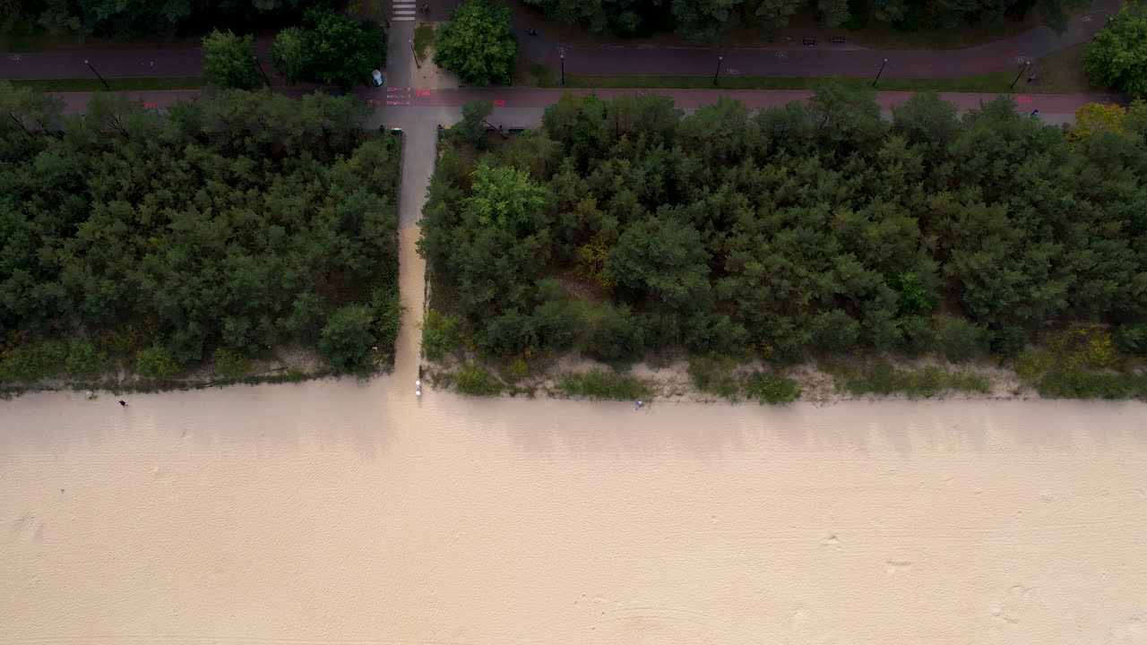 Sandy walkway from bike path leads to white sandy beach in Gdansk Poland