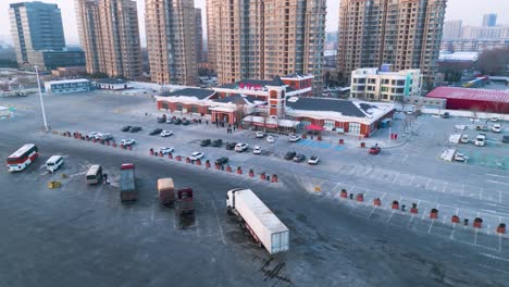 Aerial-view-over-Qingdao-Yinchuan-Expressway-in-Shandong-Province,-China,-showcasing-a-service-area-designed-to-cater-to-drivers'-diverse-needs,-including-parking,-maintenance,-and-gastronomy