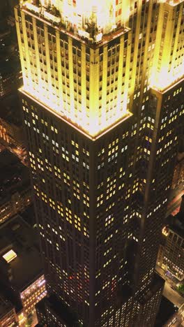 cars driving on street between high rise buildings in night city
