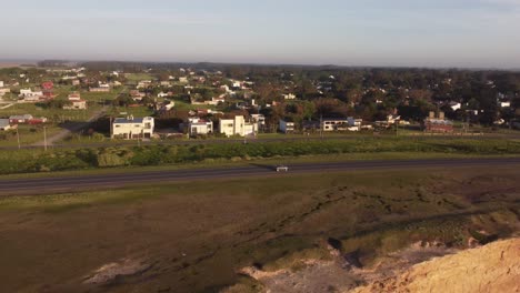 Car-driving-along-panoramic-road-near-Acantilados-cliffs-at-sunset,-Mar-del-Plata-in-Argentina