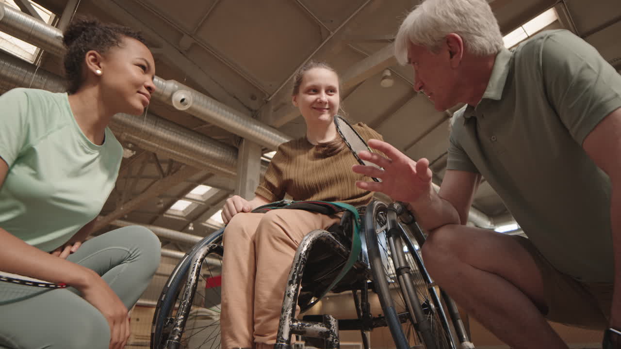 Coach and Girls Putting Hands Together