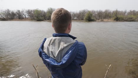 fisherman catching fish and spinning fishing reel on background river water