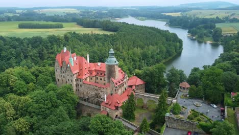 imposing czocha castle along the riverside in lower silesian voivodeship, southwestern poland. aerial drone shot