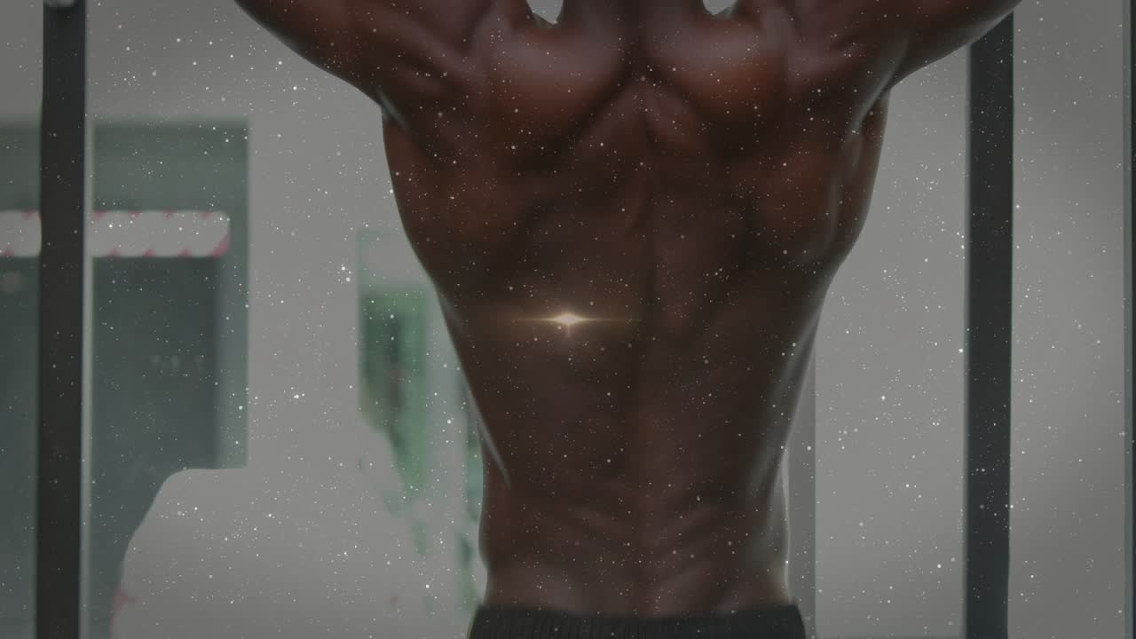 Man gripping bar, pulling up, lens flare migrating up, speckled overlay accenting back for fitness