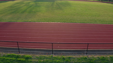 a teen girl track athlete runs track as camera tracks left