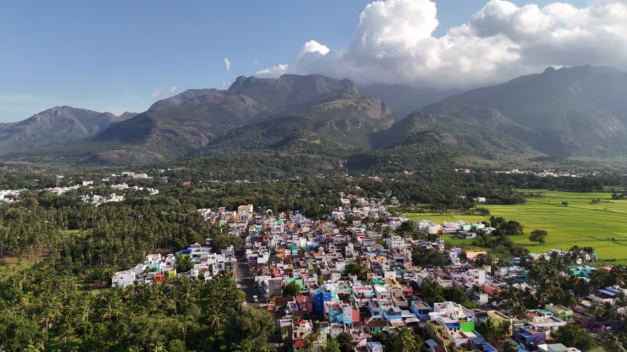 Breathtaking aerial panorama of Courtallam town nestled amid the Western Ghats, surrounded by lush tropical greenery and featuring the iconic Peraruvi waterfall. Perfect for travel or wellness visuals