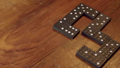 stop action style clip of domino game tiles being added to table top