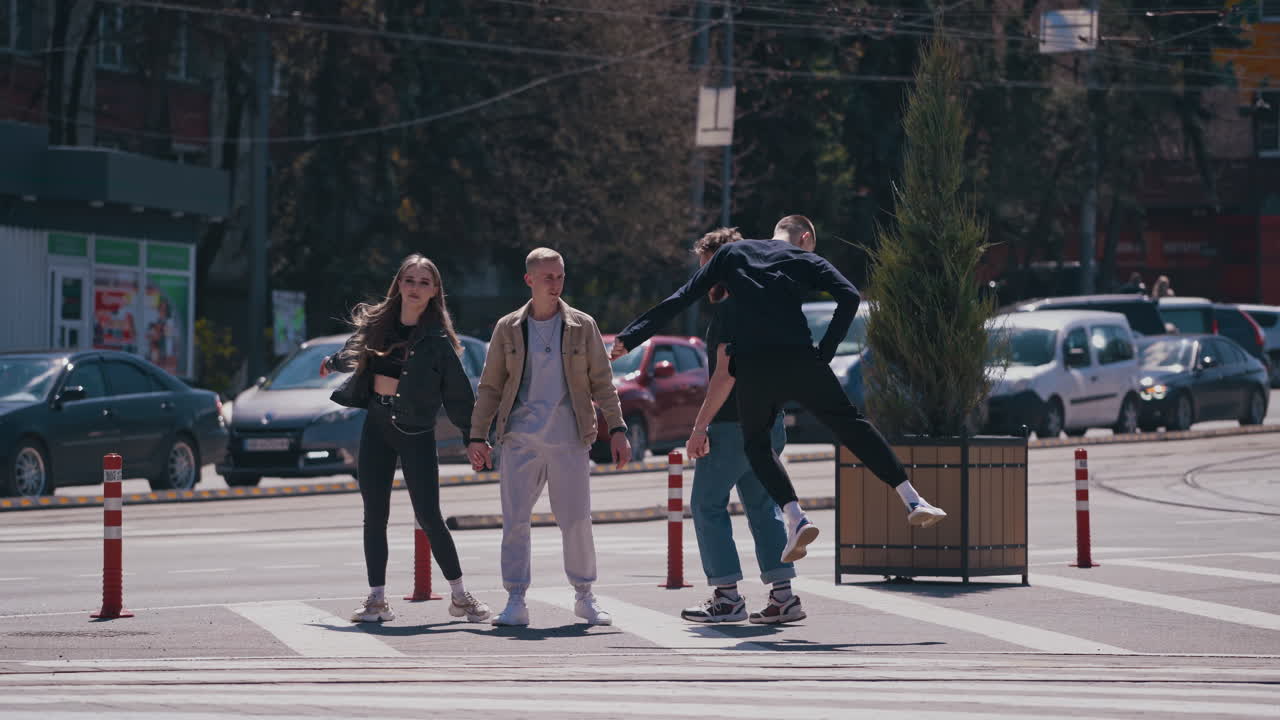 Happy friends meeting at the street. Group of young people having fun outdoors. Guys enjoy their life together