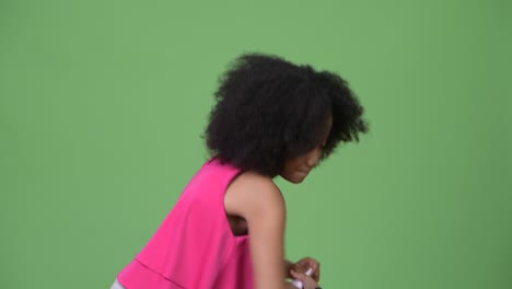 young cute african girl with afro hair crunching and throwing paperwork